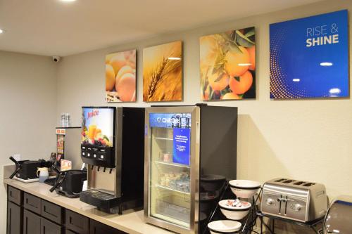 a store with a refrigerator and a counter with food at Comfort Inn & Suites Moreno Valley near March Air Reserve Base in Moreno Valley