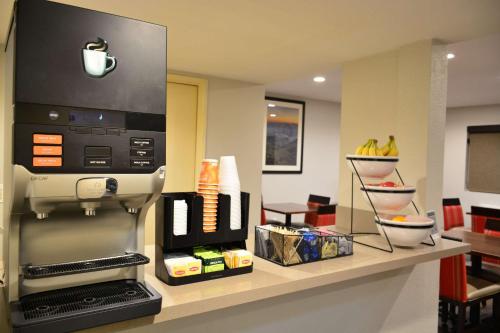 a kitchen with a coffee machine on a counter at Comfort Inn & Suites Moreno Valley near March Air Reserve Base in Moreno Valley