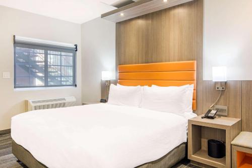 a hotel room with a large bed and a window at Rodeway Inn near Melrose Ave in Los Angeles
