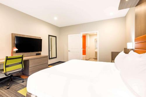 a hotel room with a bed and a television at Rodeway Inn near Melrose Ave in Los Angeles