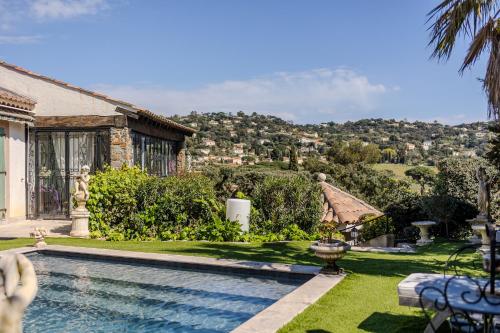 une maison avec une piscine dans une cour dans l'établissement Val de Mer - Piscine et Grand Jardin, à La Croix-Valmer