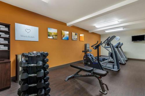 a gym with two tread machines in a room at Comfort Suites Visalia - Convention Center in Visalia