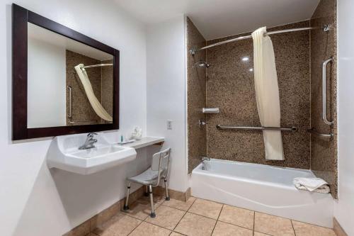 a bathroom with a sink and a tub and a shower at Rodeway Inn Carson - Los Angeles South in Carson