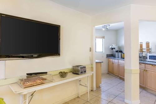 a living room with a flat screen tv on a wall at Rodeway Inn Magic Mountain Area in Castaic