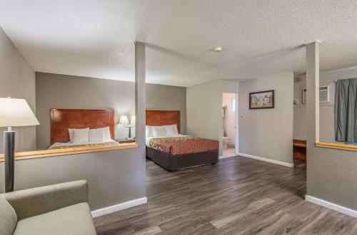 a hotel room with a bed and a couch at Econo Lodge Inn & Suites Yreka in Yreka