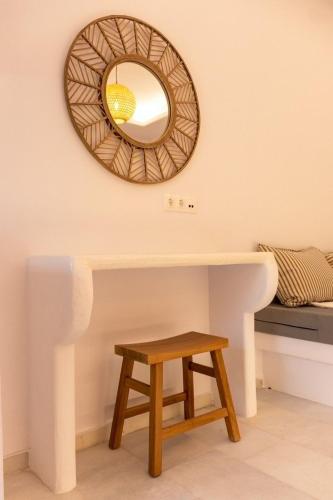 a mirror above a table with a stool at Ammos Studio Pyrgaki Naxos in Agiassos