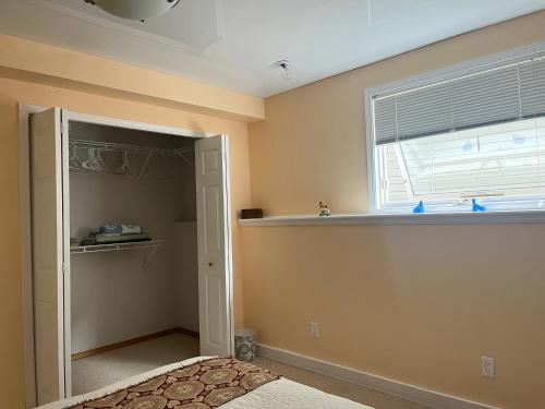 a bedroom with a bed and a window and a closet at citadle hill house! in Calgary