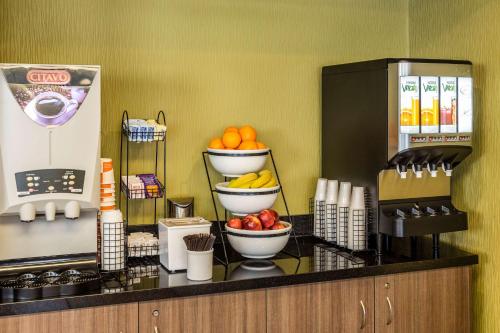a kitchen with bowls of fruit on a counter at Comfort Inn in Sydney