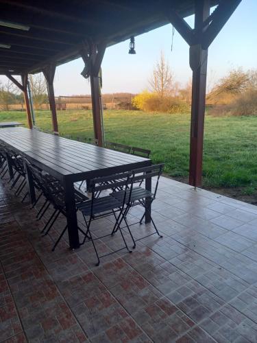 a picnic table and benches under a gazebo at Horpácsi Európa Pihenő Központ in Horpács