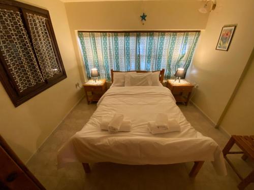 a bedroom with a bed with two towels on it at Sea View 180' in Kalymnos