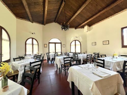 a dining room with white tables and chairs at Locanda Sul Lago in Santo Stefano di Sessanio