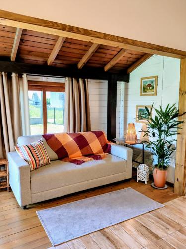 a living room with a couch and a table at Casa das Dunas in Garopaba