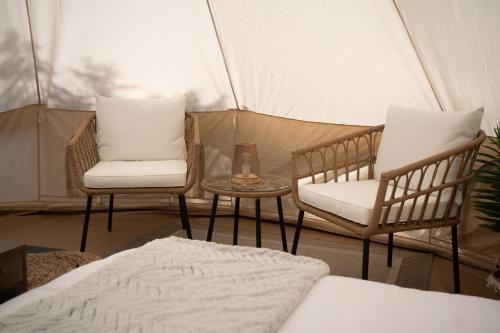 two chairs and a table in a tent at Grotto Getaway in Miller Lake