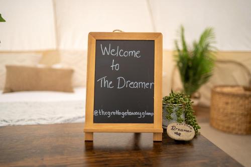 a sign that says welcome to the dreamer on a table at Grotto Getaway in Miller Lake