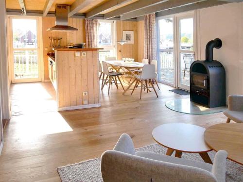 a living room with a wood stove and a table at Ferienpark Scharmützelsee in Wendisch Rietz