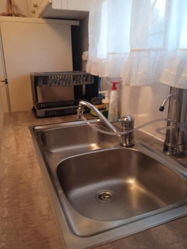 a stainless steel sink in a kitchen with a toaster oven at Niki's House in Gythio