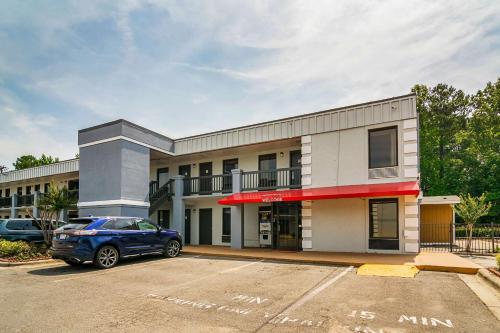 a car parked in a parking lot in front of a building at Econo Lodge Research Triangle Park in Durham