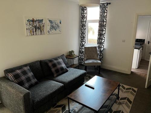 a living room with a couch and a coffee table at ResiLets - Ground Plessey Road Apt in Cowpen