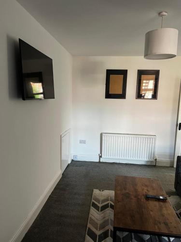 a living room with a table and a couch at ResiLets - Ground Plessey Road Apt in Cowpen