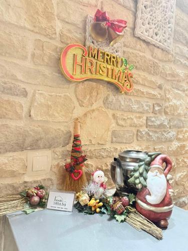 a table with a merry christmas sign on a wall at Villa Adis with Hot Pool & Jacuzzi by BookVillaBG in Borovets
