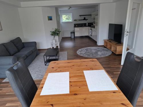 a living room with a wooden table and a couch at Kurstadt-Appartement Bad Wildungen in Bad Wildungen