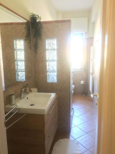 a bathroom with a white sink and a mirror at Casa Mare Verde in Casamicciola Terme