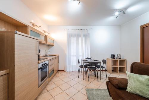 a kitchen and living room with a table and a couch at Milan Navigli Darsena - In City Center - AC in Milan
