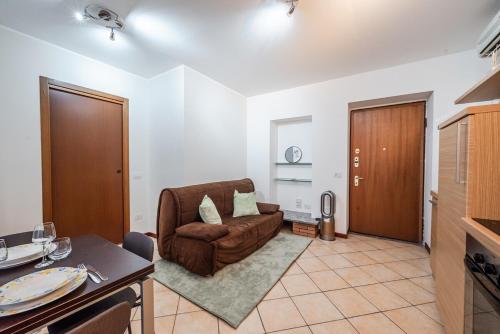 a living room with a couch and a table at Milan Navigli Darsena - In City Center - AC in Milan
