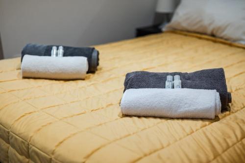 two towels are sitting on top of a bed at Milan Navigli Darsena - In City Center - AC in Milan