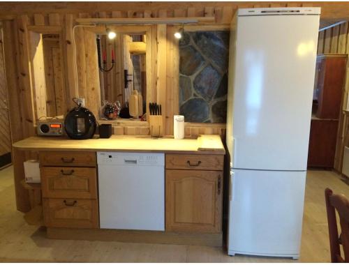 a kitchen with a white refrigerator in a room at HyttaMi in Stranda