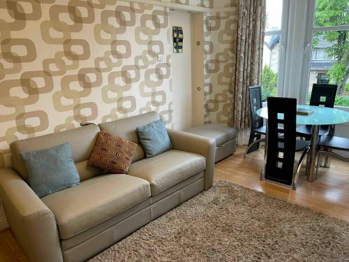 a living room with a couch and a table at Scotstoun 1 Bed Flat in Glasgow