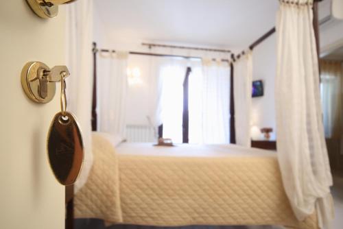 a bedroom with a canopy bed with a window at Willaria Country House in Cursi
