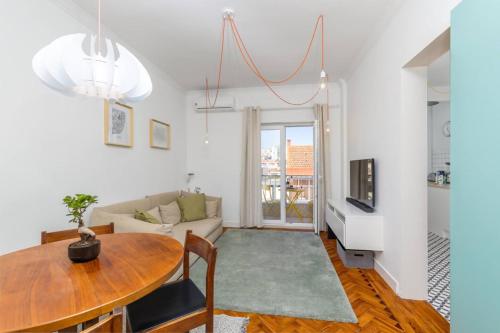 a living room with a table and a couch at Near Lisbon Apartment in Amadora