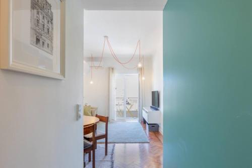 a living room with a table and a dining room at Near Lisbon Apartment in Amadora