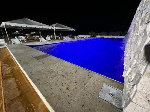 a swimming pool at night with blue water at Antonios Miramar Hotel in Ciudad Madero