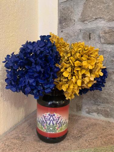 a vase filled with blue and yellow flowers at Ca di Viet in San Giorio