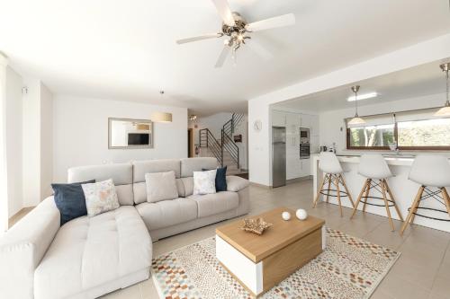a living room with a white couch and a table at Charming Villa Óbidos by LovelyStay in Casal do Narcizo