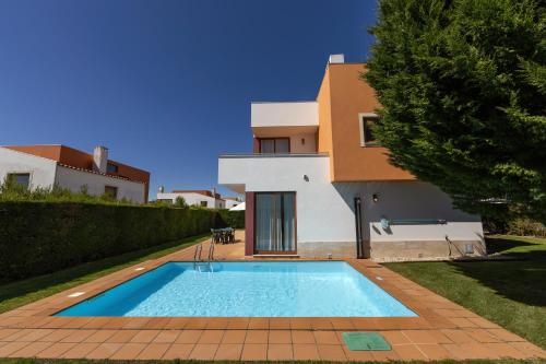 a swimming pool in front of a house at Charming Villa Óbidos by LovelyStay in Casal do Narcizo