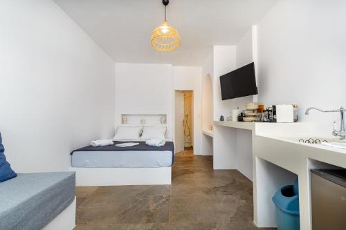 a small room with a bed and a kitchen at Aitheras Luxury Suites in Protorgia