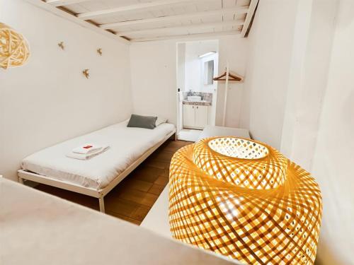 a white room with a bed and a yellow chair at Magnifique Appartement 8 personnes hyper centre in Montpellier