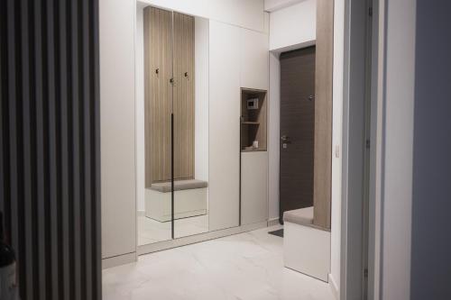 a room with white walls and a walk in closet at Unirea Towers Deluxe Apartment Modern & Chic in Iaşi