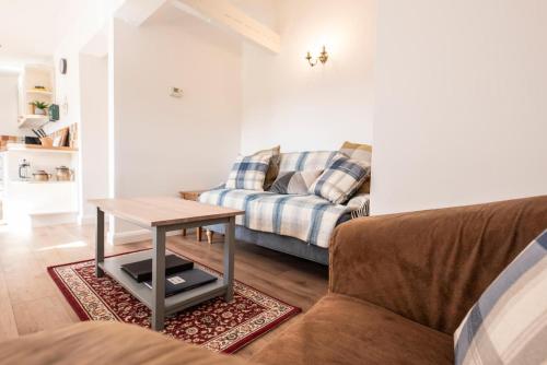 a living room with a couch and a table at The Old Dairy in Cookley
