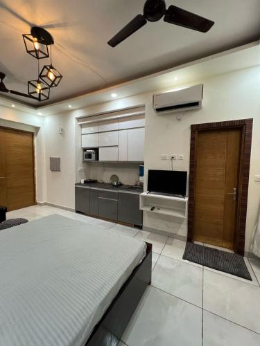a large room with a bed and a kitchen at The Humble Hosts in Noida