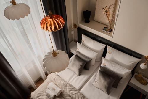 a room with a white couch and pillows at OLD TOWN Charm & Chic by Downtown Apartments in Kraków