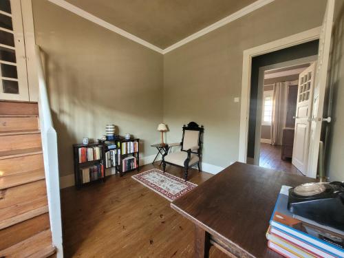 an empty living room with a table and books at A Casa do Escritor in Vila do Conde