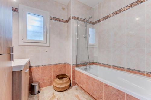 une salle de bain avec une baignoire et un lavabo dans l'établissement Havre de paix - Wifi, AC, parking, 4 pers, à Nice