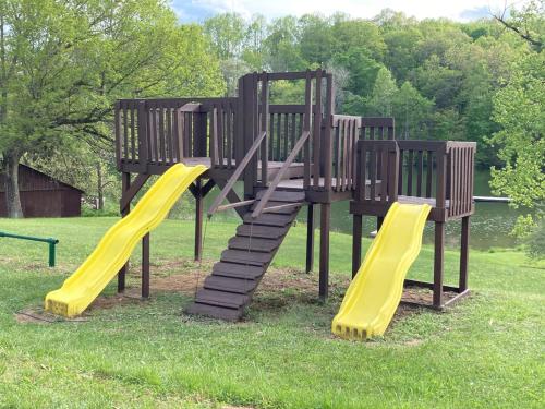 a playground with a slide in the grass at Trillium Ridge, Hocking Hills Area, 2 Bedroom, 3 Beds in Rockbridge