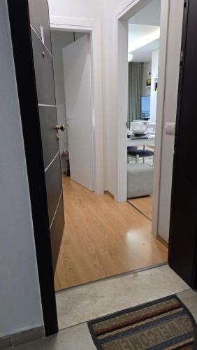 a hallway with a door and a living room at Tirana Garden Rezidence Turdiu in Tirana