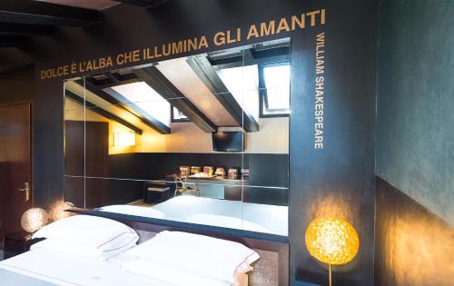 a room with two beds and a sign that readspolice lula gell am at Phi Hotel Bologna in Bologna