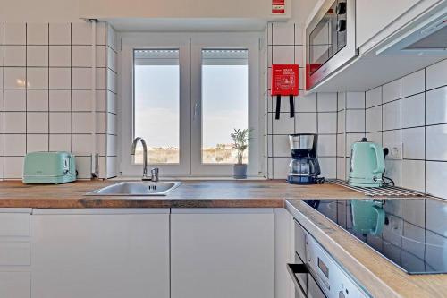 a kitchen with a sink and a counter top at Sea Salt, Sagres Apartment in Sagres